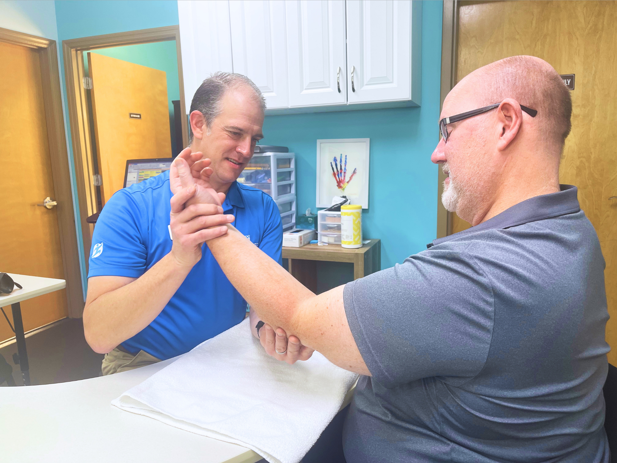Physical Therapist Healing Patient hand wrist elbow pain
